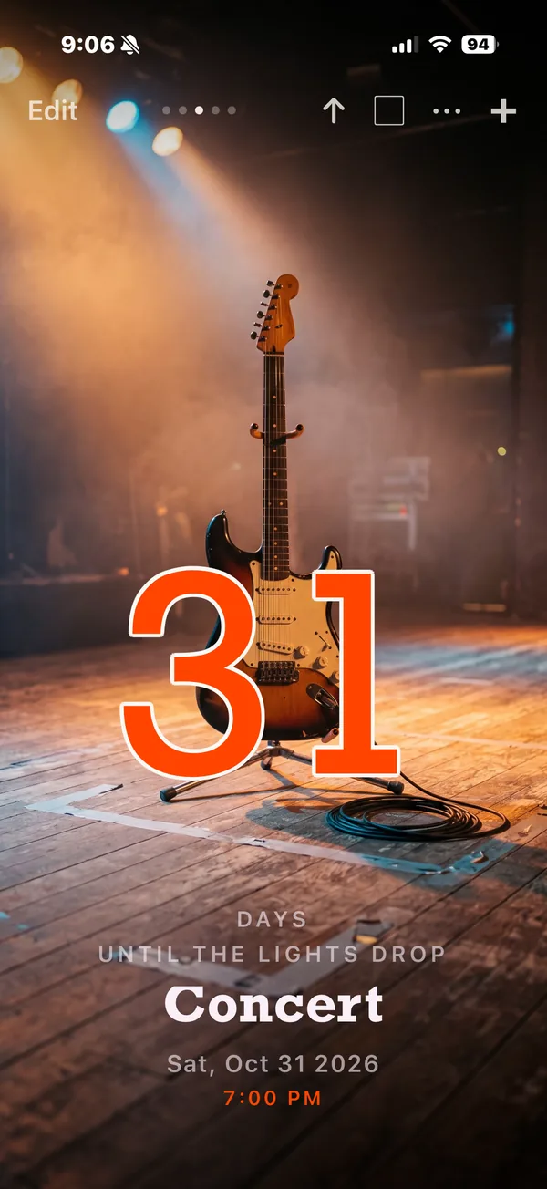 Nigh countdown: 31 days until the lights drop for a concert, over an electric guitar on a stage.