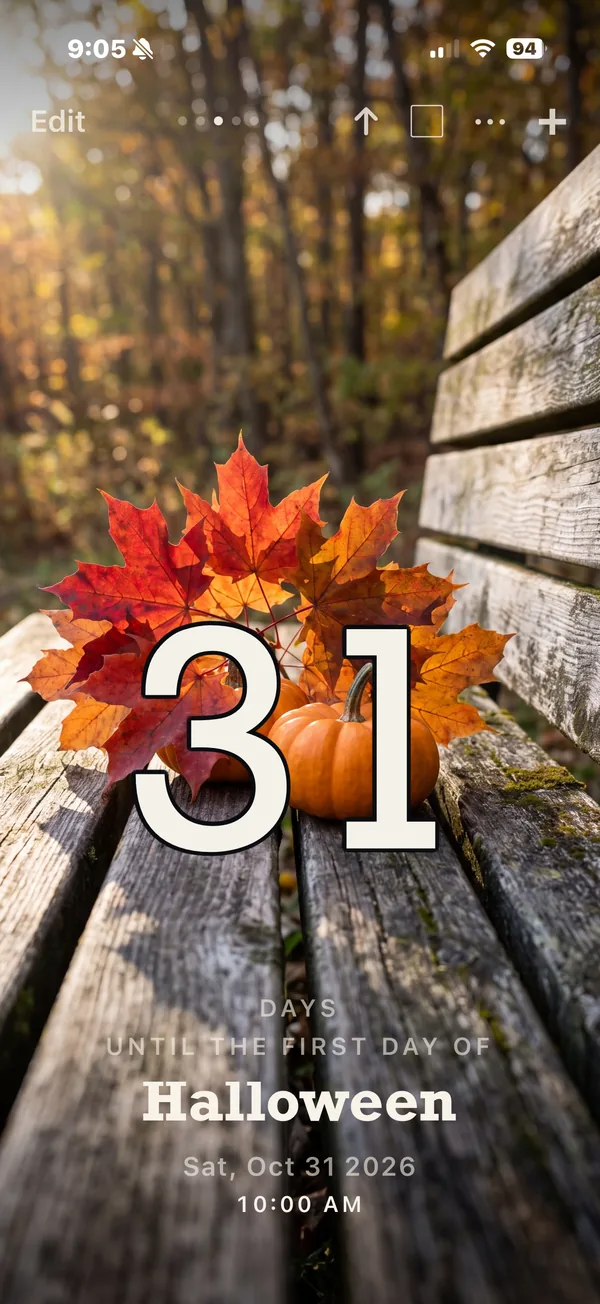 Nigh countdown: 31 days until the first day of Halloween, over autumn leaves and a pumpkin on a bench.